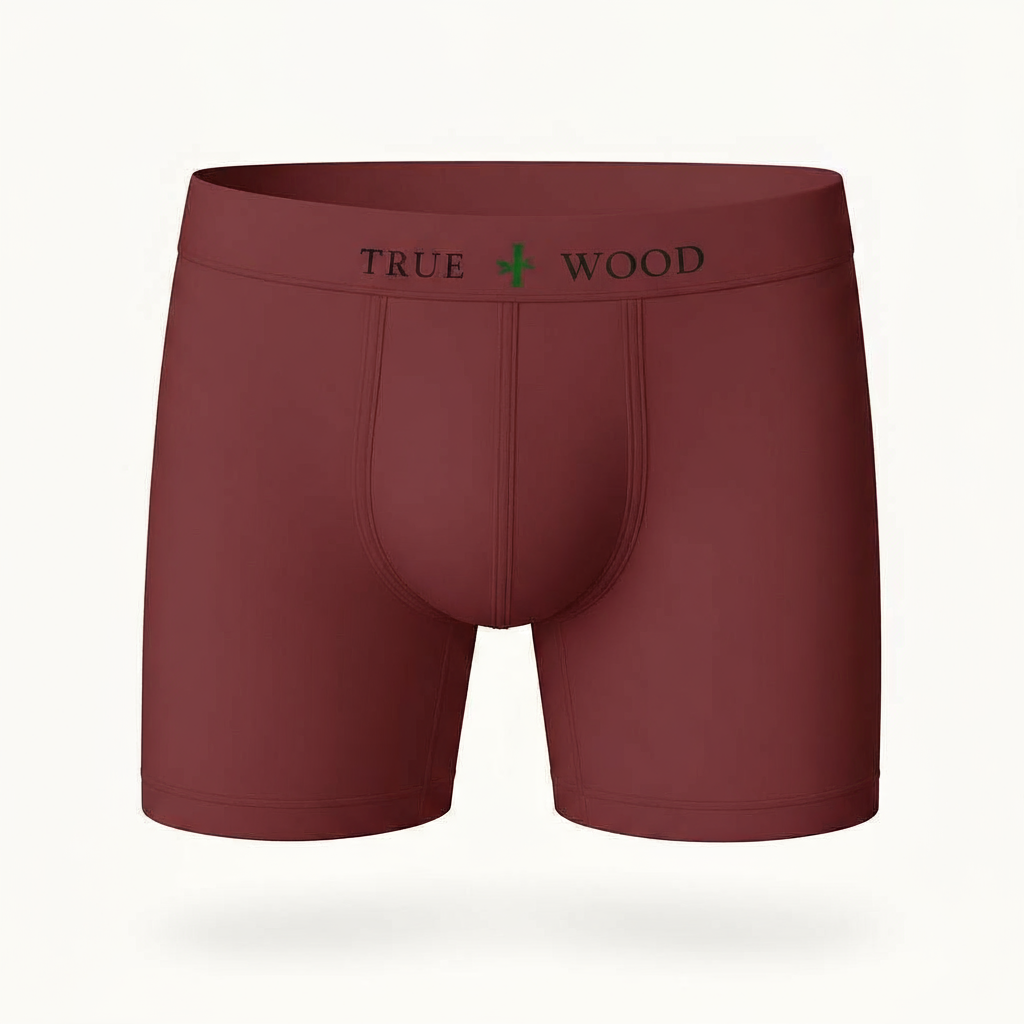 Maroon men's boxer briefs with the words 'TRUE WOOD' in black and a green leaf icon on the waistband, styled in a clean serif font, displayed against a light background.
