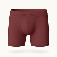 Maroon men's boxer briefs with the words 'TRUE WOOD' in black and a green leaf icon on the waistband, styled in a clean serif font, displayed against a light background.